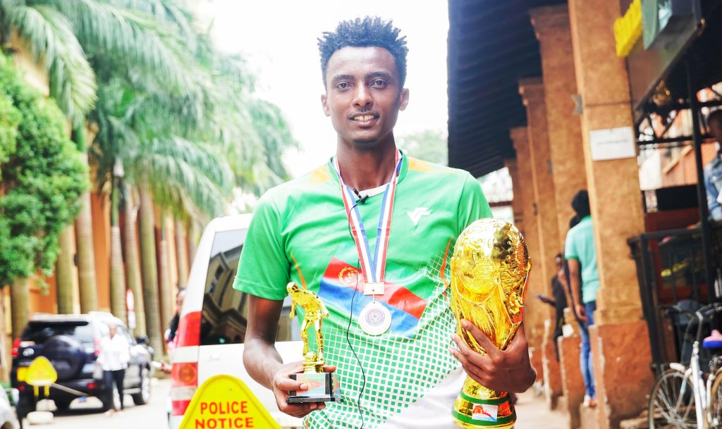 Noah Iyasu, the captain of Team Denden holding the trophy after the win against the Team Warsay who were the champions last year.